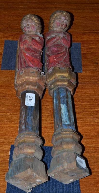 Lot 316 - A pair of religious polychrome decorated figures, probably furniture mounts