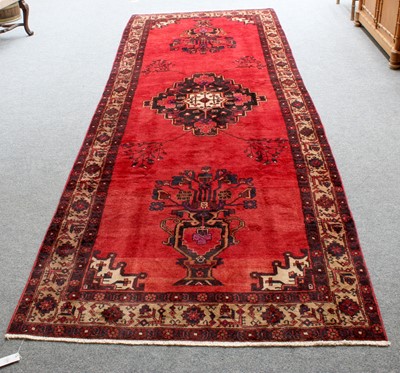 Lot 1295 - North West Persian Village Rug, the blood red...