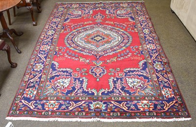 Lot 1283 - Tabriz Rug, the blood red field centred by a...