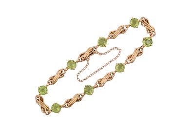 Lot 2201 - A Peridot Bracelet eight round cut peridots in...