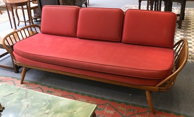 Lot 1209 - An Ercol Elm Sofa, red upholstered cushions,...