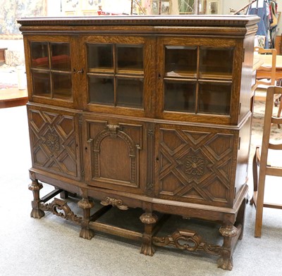 Lot 1201 - A 1920s Oak Cabinet, the three glazed doors...