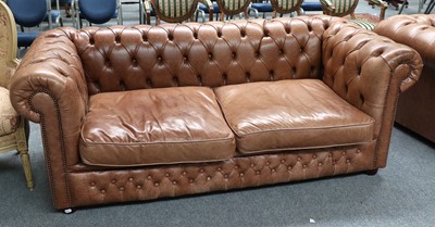 Lot 1251 - A Tan Leather Chesterfield Style Sofa,...