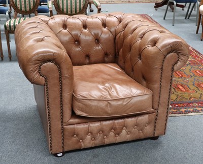 Lot 1250 - A Tan Leather Chesterfield Style Armchair,...