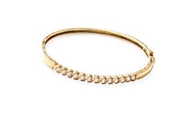 Lot 282 - A 9 Carat Gold Cubic Zirconia Hinged Bangle,...