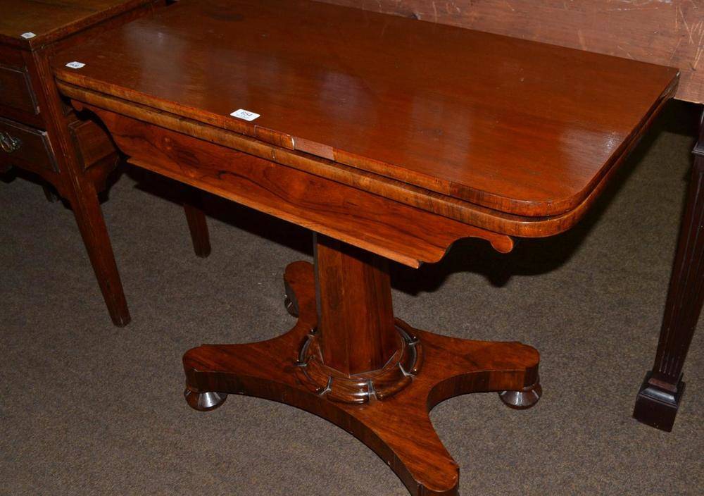 Lot 654 - Rosewood fold-over card table with later top