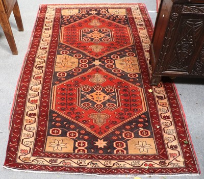 Lot 1206 - West Persian Rug, the charcoal field with two...