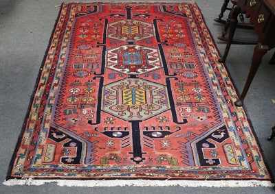 Lot 1207 - North West Persian Rug, the faded blood red...