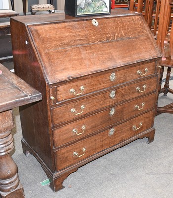 Lot 1288 - A George III Oak Bureau, banded in mahogany...