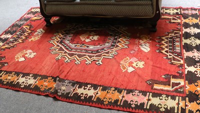 Lot 1210 - Konya Kilim, the brick red field centred by a...