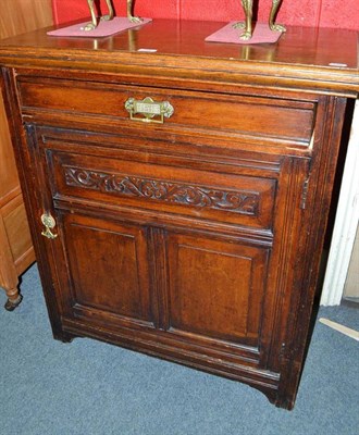 Lot 758 - A Victorian oak cupboard with carved panels