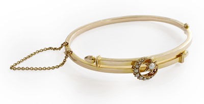 Lot 224 - A Split Pearl Bangle, the yellow plain...