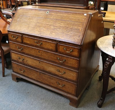 Lot 1214 - A George III Oak Bureau, banded in mahogany...