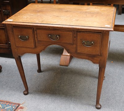 Lot 1311 - A George III Oak Three Drawer Lowboy, with...