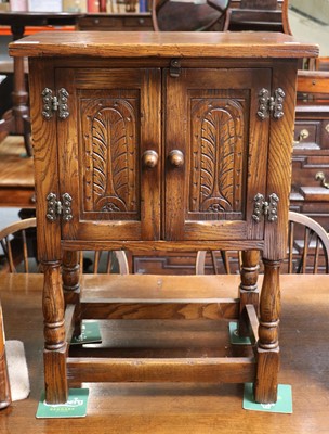 Lot 1179 - A Reproduction Carved Oak Two Door Side...