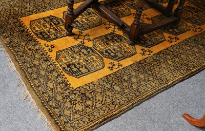 Lot 1088 - Afghan "Gold" Rug, the field with two columns...