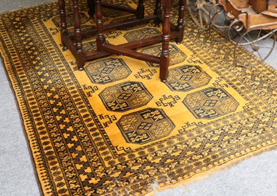 Lot 1088 - Afghan "Gold" Rug, the field with two columns...