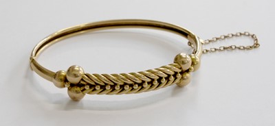 Lot 285 - A Hinged Bangle, stamped '15', with rope work...