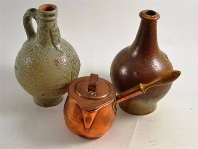Lot 2 - An early 18th century saltglaze stoneware wine bottle, a 19th century bellarmine, a copper saucepan