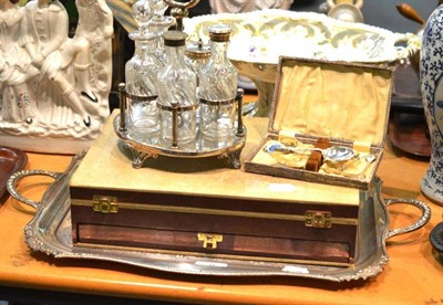 Lot 9 - A silver plated five bottle cruet; a two handled tea tray; a canteen of plated flatware and a...