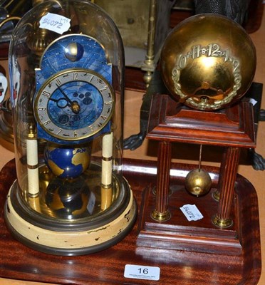 Lot 16 - A Kaiser four hundred day mantel timepiece with enamelled dial and globe pendulum on a plinth under