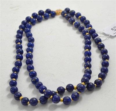 Lot 53 - A double strand of lapis lazuli beads with gilt metal spacers