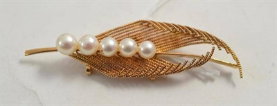 Lot 62 - A cultured pearl stylised leaf brooch, stamped '14k'