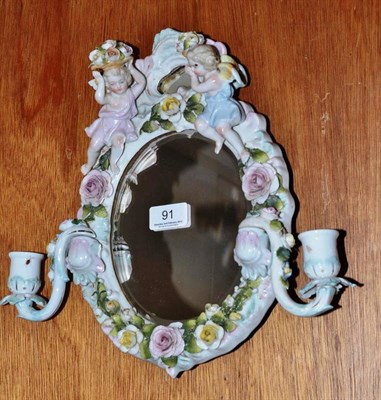 Lot 91 - Sitzendorf mirror with twin candlestick holders
