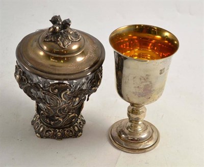 Lot 98 - Glass jar with pierced and foliate white metal stand and cover and a modern silver goblet (2)