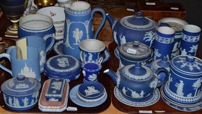 Lot 115 - Assorted Wedgwood blue Jasperware jugs, tobacco jars and cover, cylindrical vases etc (on two...