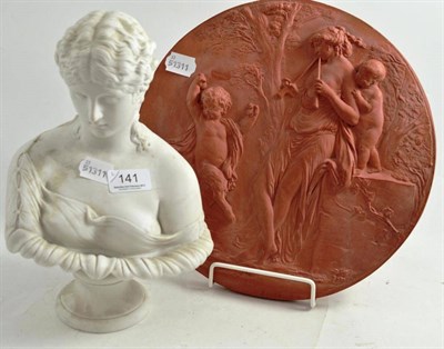 Lot 141 - Terracotta roundel embossed with a dancing satyr and a bisque bust of a maiden (2)
