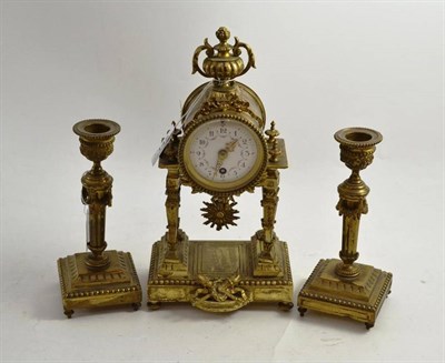 Lot 145 - Gilt metal clock garniture with enamel dial