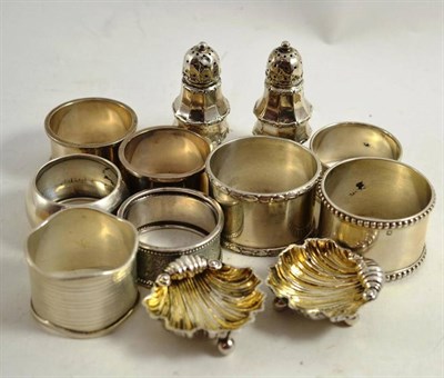 Lot 160 - Pair of silver shell shaped dishes, a pair of pepperettes and eight napkin rings