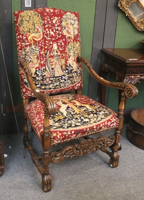 Lot 1241 - A Baronial Style Carved Walnut Armchair, with...