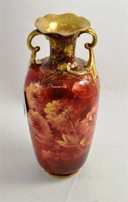 Lot 220 - A Doulton Burslem twin handled vase with floral decoration on a red ground