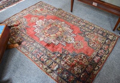 Lot 1239 - Turkish Rug, the strawberry field centred by a...