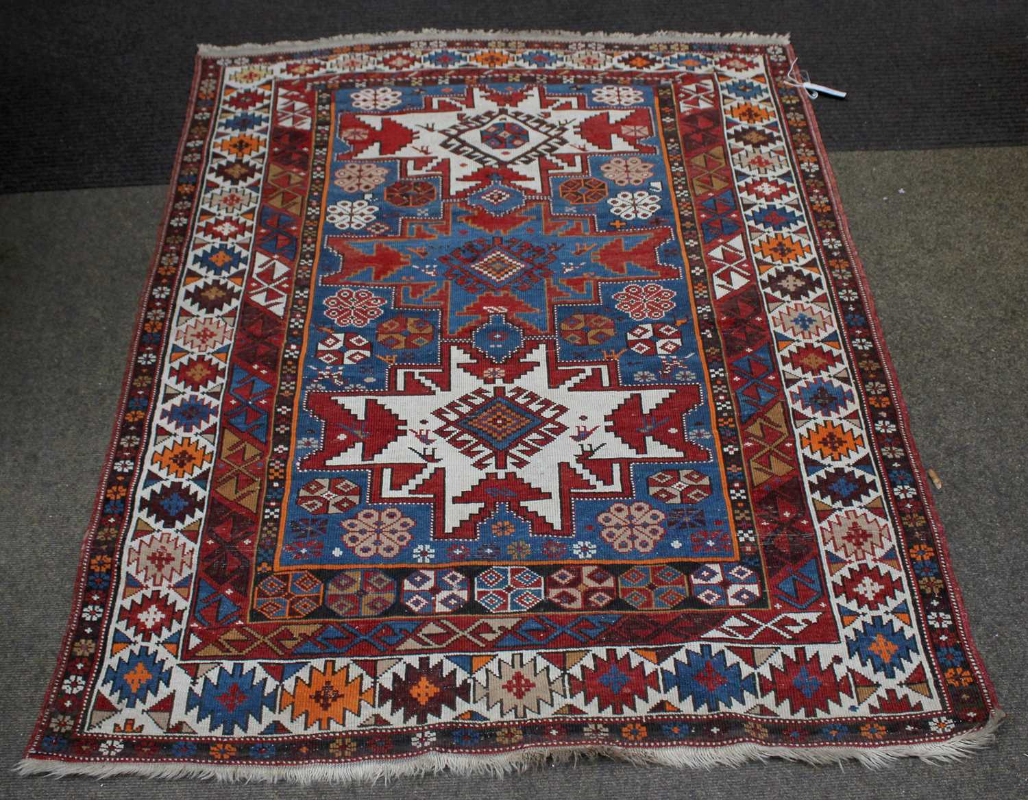 Lot 1106 - Daghestan Rug, the mid-indigo field with three...