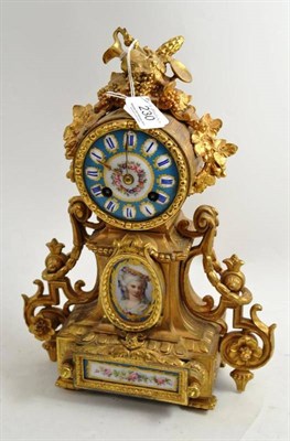 Lot 230 - Gilt metal mounted mantel clock with porcelain plaques and pendulum
