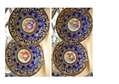 Lot 248 - Four Royal Worcester plates in blue and gilt, painted to the centre with fruit, signed...