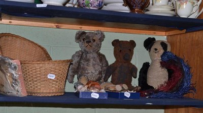 Lot 254 - A shelf including two teddy bears, a panda, a wicker cradle, a composition doll, miniature...