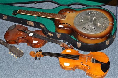 Lot 258 - Two violins, a flat back mandolin and a damaged guitar, cased