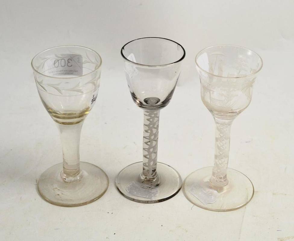 Lot 300 - Two 18th century wine glasses and a later engraved wine glass depicting figures (3)