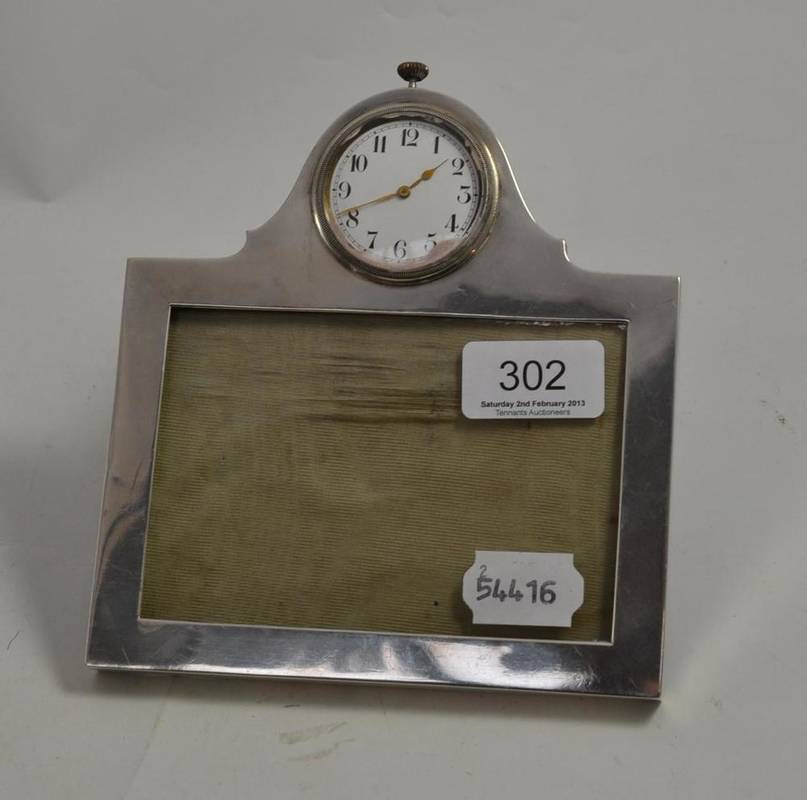 Lot 302 - A silver mounted picture frame containing a watch
