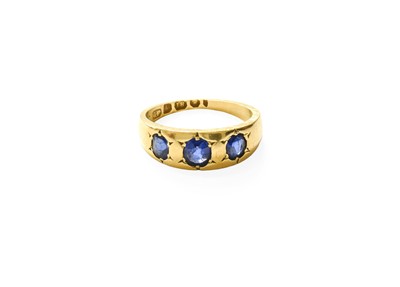 Lot 436 - An 18 Carat Gold Sapphire Three Stone Ring,...