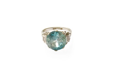 Lot 447 - A Blue Zircon and Diamond Ring, the round cut...