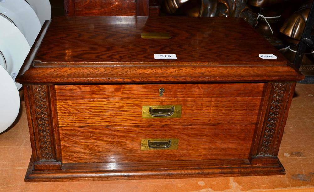 Lot 319 - An oak canteen with inset brass handles and provisions for a twelve place table service