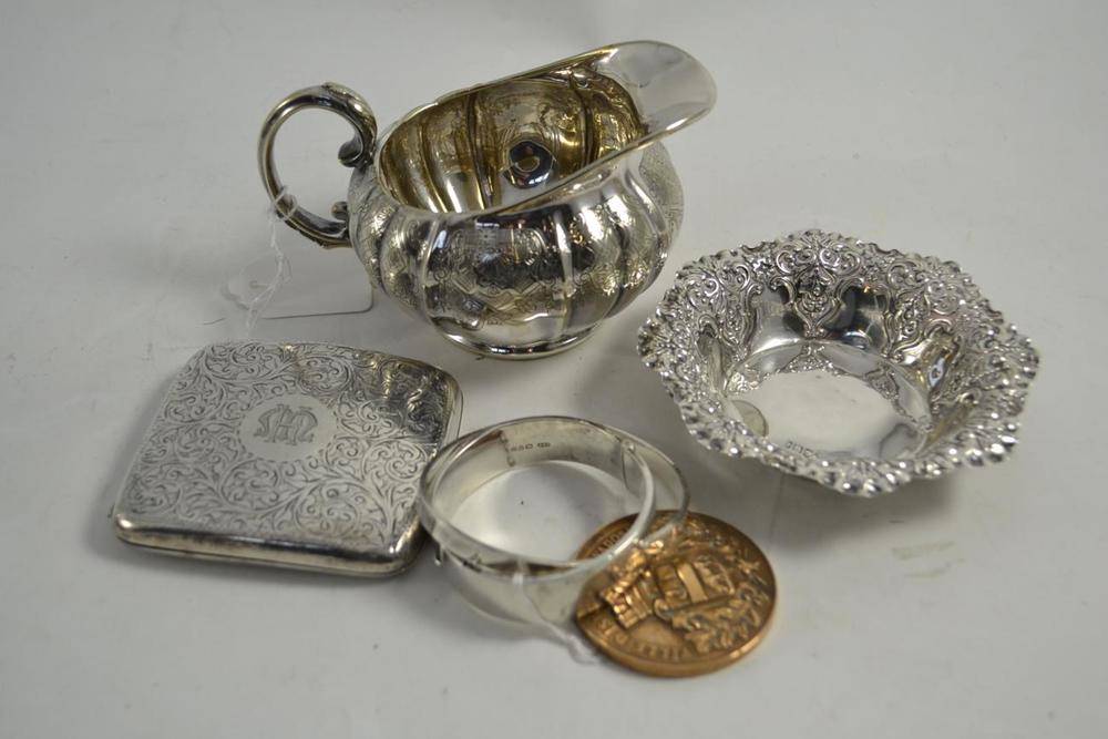 Lot 344 - A silver cream jug, a sugar bowl, a silver topped bottle and two others (5)
