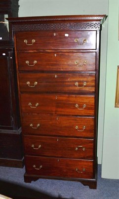 Lot 420 - A mahogany tall chest of seven drawers with blind fret cut frieze