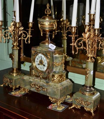 Lot 424 - A green onyx and gilt metal mounted clock garniture