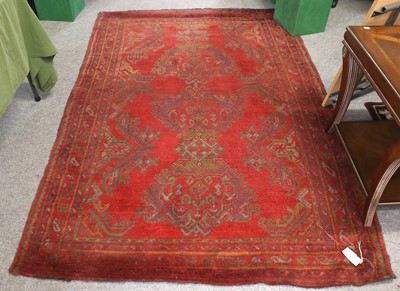 Lot 1135 - Ushak Rug, the tomato red field with three...